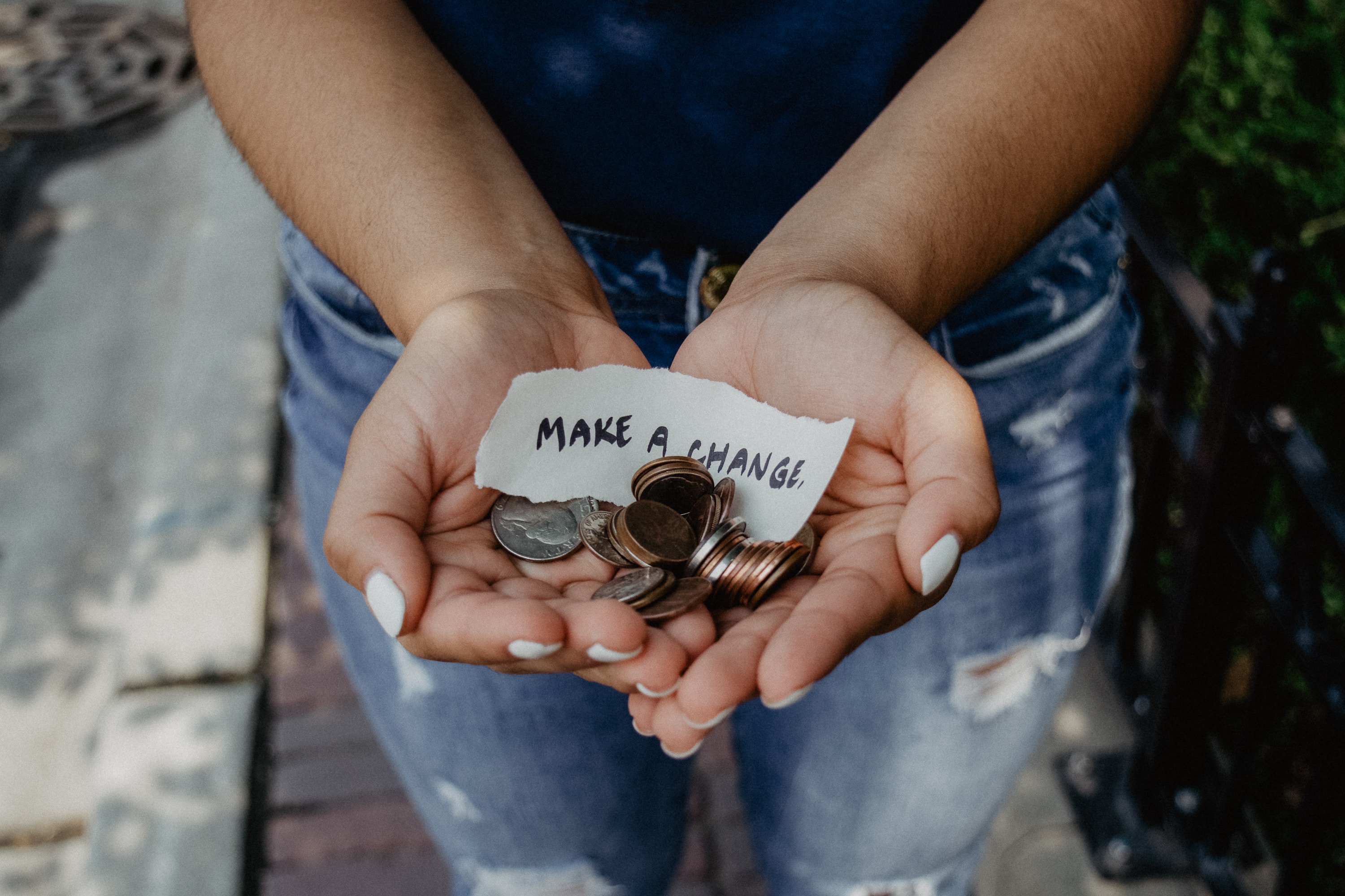 Hands holding loose change.