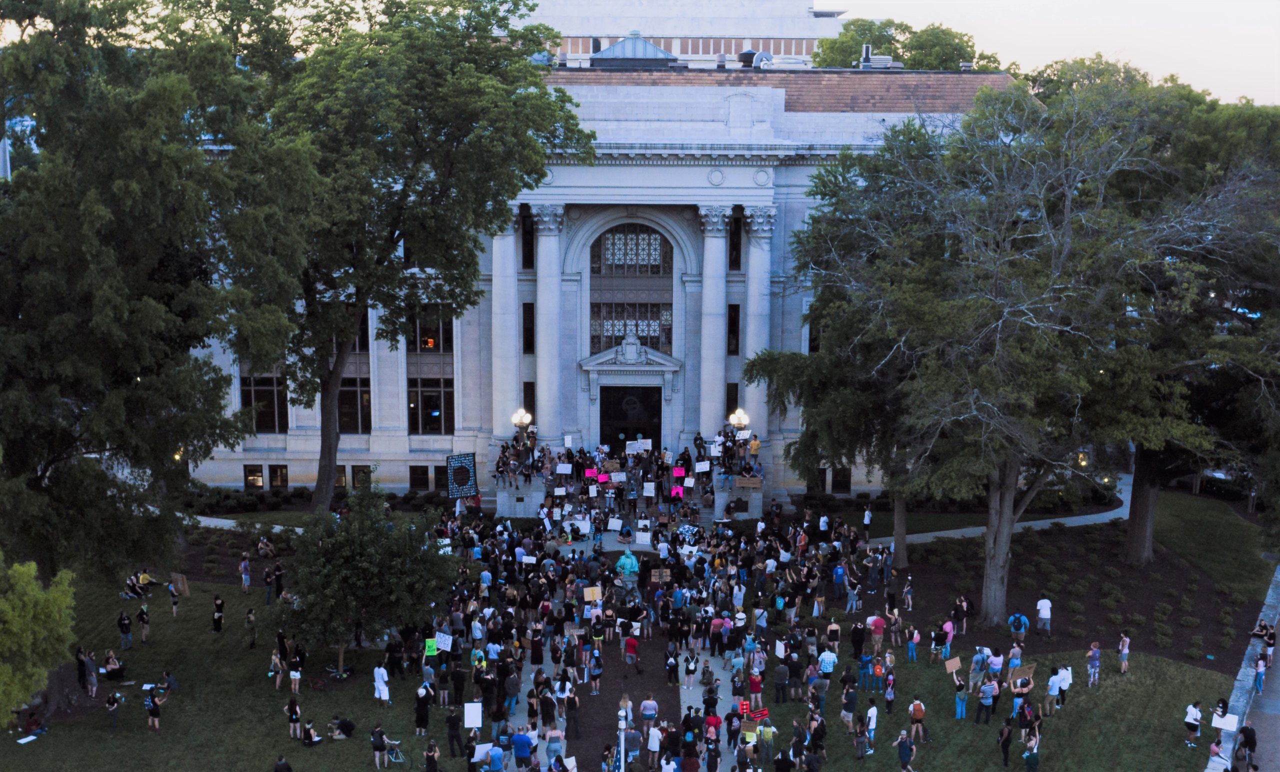 Protesters gathered in front of a building