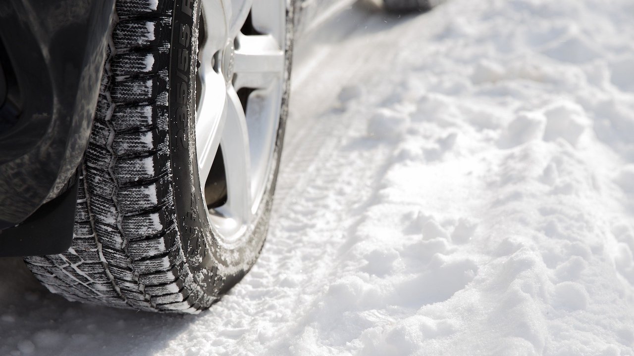A car tire in the snow.
