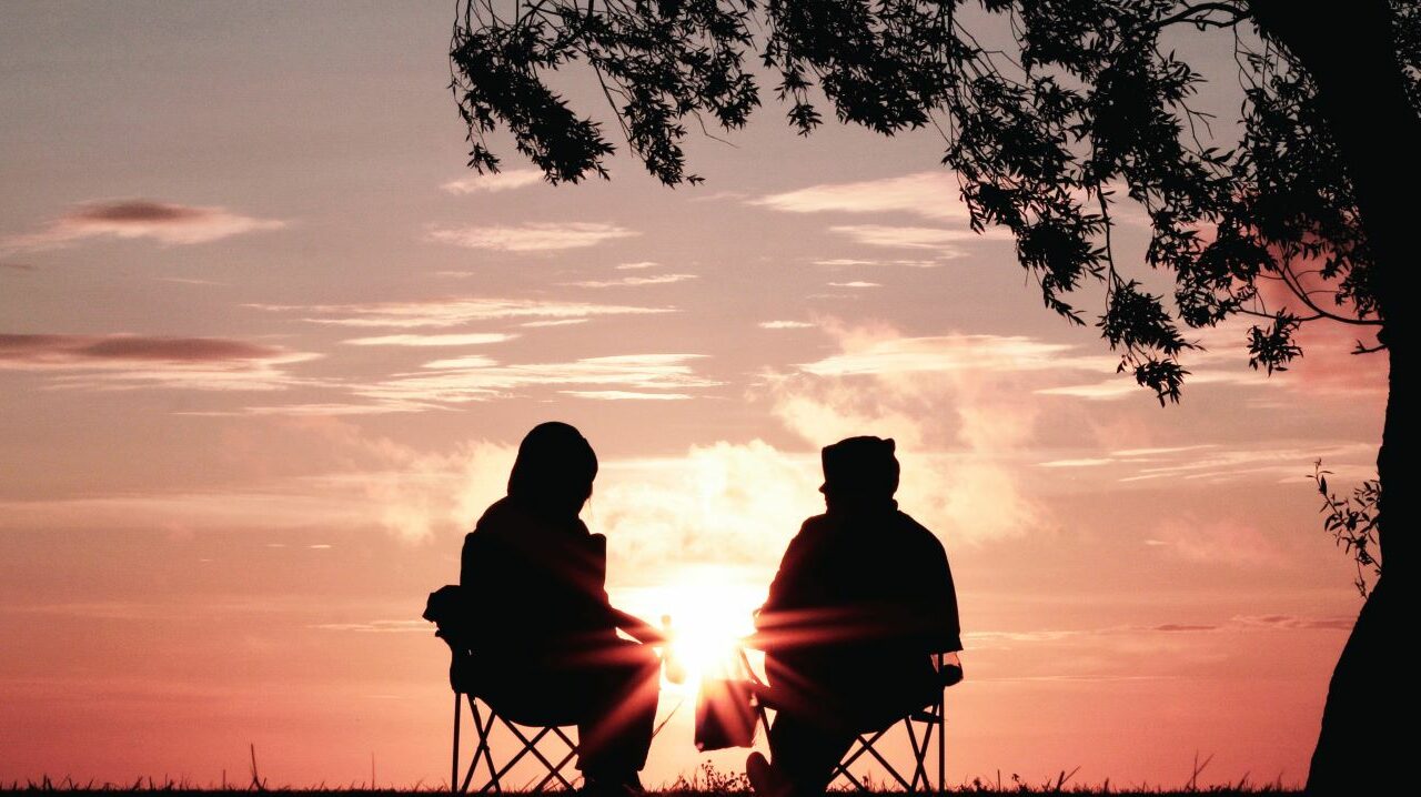 Two people watching a sunset.