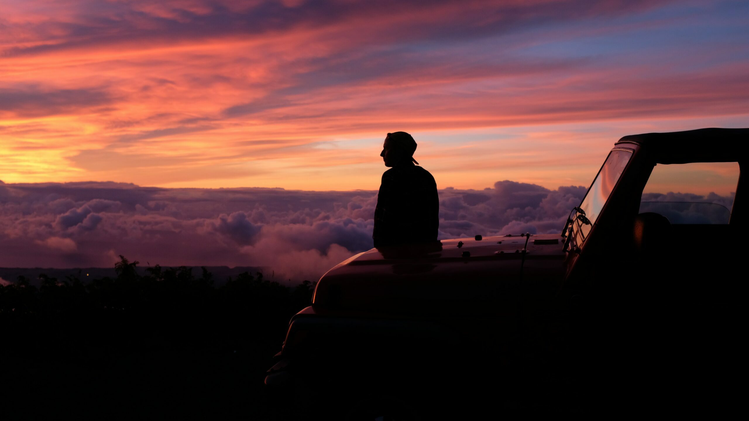 A person looking at a sunset.